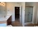 Bathroom featuring a vanity, shower with glass door, and doorway to bedroom at 298 Weyburn St., Myrtle Beach, SC 29579