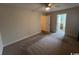 Spacious bedroom with carpet and ceiling fan, leading to ensuite bathroom at 298 Weyburn St., Myrtle Beach, SC 29579