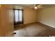 A light filled bedroom with a ceiling fan and neutral carpet at 298 Weyburn St., Myrtle Beach, SC 29579