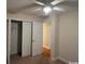 Bedroom featuring a closet with double doors, ceiling fan and carpeted floors at 298 Weyburn St., Myrtle Beach, SC 29579