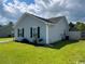 Side exterior view of a gray single-story house with a well-maintained lawn at 298 Weyburn St., Myrtle Beach, SC 29579
