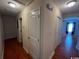 Hallway with hardwood floors leading to bedroom with ceiling fan at 298 Weyburn St., Myrtle Beach, SC 29579