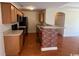 Well-lit kitchen featuring wooden cabinetry and a brick-accented breakfast bar at 298 Weyburn St., Myrtle Beach, SC 29579