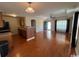 Open-concept living room features hardwood floors, a ceiling fan, and a brick accent bar at 298 Weyburn St., Myrtle Beach, SC 29579