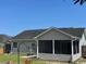 View of screened in porch with gray siding and well maintained lawn at 298 Weyburn St., Myrtle Beach, SC 29579