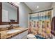 Bathroom featuring a granite countertop, beach-themed shower curtain, and light fixtures at 301 Farmtrac Dr., Galivants Ferry, SC 29544