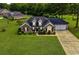 Beautiful brick house with manicured lawn and shrubs, complemented by an attached two-car garage and charming dormers at 301 Farmtrac Dr., Galivants Ferry, SC 29544