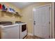 Functional laundry room with washer, dryer, and shelving for storage at 301 Farmtrac Dr., Galivants Ferry, SC 29544