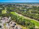 An aerial shot of a condominium complex next to a golf course, showcasing landscaping and the building's layout at 3015 Old Bryan Dr. # 4, Myrtle Beach, SC 29577