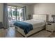 Bright bedroom featuring a bed with drawer storage, nightstands and sliding glass doors to a balcony at 3015 Old Bryan Dr. # 4, Myrtle Beach, SC 29577