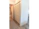 Hallway featuring a closet with folding doors and a view into a bathroom at 3015 Old Bryan Dr. # 4, Myrtle Beach, SC 29577