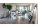 Open-concept dining area with table set and comfortable living room with lots of light at 3015 Old Bryan Dr. # 4, Myrtle Beach, SC 29577