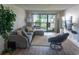 Comfortable living room featuring a large sofa, modern furniture, hardwood floors, and natural light at 3015 Old Bryan Dr. # 4, Myrtle Beach, SC 29577