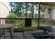 Relaxing patio view with outdoor furniture, a small black trampoline, and a scenic view of the surrounding trees at 3015 Old Bryan Dr. # 4, Myrtle Beach, SC 29577