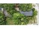 An aerial view shows a rooftop surrounded by many green leafy trees at 304 1St Ave. N, Myrtle Beach, SC 29577