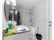 Bathroom featuring a mirror, toilet, and a small white washing machine at 304 1St Ave. N, Myrtle Beach, SC 29577