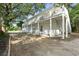 Side view of a two-story home with a balcony supported by wooden pillars at 304 1St Ave. N, Myrtle Beach, SC 29577