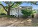 Charming exterior showcasing the covered porch, mature landscaping, and classic architectural details at 304 1St Ave. N, Myrtle Beach, SC 29577