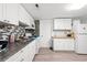 Well-lit kitchen featuring white cabinets, modern appliances, and stylish backsplash at 304 1St Ave. N, Myrtle Beach, SC 29577