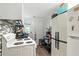 Compact kitchen with white cabinets, electric range, tile backsplash, and modern appliances at 304 1St Ave. N, Myrtle Beach, SC 29577