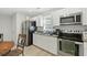Eat-in kitchen with stainless steel appliances, white cabinets, granite countertops at 304 1St Ave. N, Myrtle Beach, SC 29577