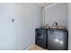 This laundry room features a washer and dryer and blue wooden walls at 304 1St Ave. N, Myrtle Beach, SC 29577