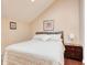 Bright bedroom features wood floors, an angled ceiling, and a comfortable bed at 306 21St Ave. S # 5H, Myrtle Beach, SC 29577