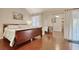 Bright bedroom features a comfortable bed, mirrored closet, and hardwood flooring at 306 21St Ave. S # 5H, Myrtle Beach, SC 29577