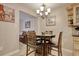 Cozy dining area features a glass-top table, comfortable chairs, and stylish chandelier lighting at 306 21St Ave. S # 5H, Myrtle Beach, SC 29577