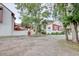 View of the home's exterior with trees and a gravel driveway on a cloudy day at 306 21St Ave. S # 5H, Myrtle Beach, SC 29577