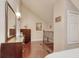 Hallway with high ceilings and wood flooring leading to dresser with mirror and staircase at 306 21St Ave. S # 5H, Myrtle Beach, SC 29577
