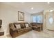 Comfortable living room featuring tile floors, a large comfortable sofa, and a front door at 306 21St Ave. S # 5H, Myrtle Beach, SC 29577