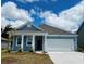 Charming one-story home showcasing blue siding, white trim, a two-car garage, and a well-manicured lawn at 3537 Ashridge Way, Conway, SC 29526