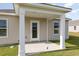 Covered patio with white columns, a view of the backyard, and a rear entrance with glass door at 394 Acosta Circle, Conway, SC 29527
