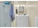 Bright bathroom featuring a single vanity, storage, and a shower with glass doors at 3969 Murrells Inlet Rd., Murrells Inlet, SC 29576