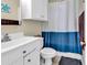 Small bathroom featuring a white sink and toilet with a two-tone shower curtain at 3969 Murrells Inlet Rd., Murrells Inlet, SC 29576