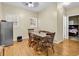 Simple dining room with wood floors, a table with chairs, and stainless refrigerator at 3969 Murrells Inlet Rd., Murrells Inlet, SC 29576