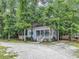 Charming single story home featuring a porch and an abundance of trees at 3969 Murrells Inlet Rd., Murrells Inlet, SC 29576