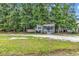 Lovely home nestled among mature trees on a grassy, gravel-covered lot at 3969 Murrells Inlet Rd., Murrells Inlet, SC 29576