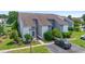 Aerial view of a well-maintained townhome with manicured lawns and ample parking under a clear sky at 4049 Fairway Lakes Dr. # 4049, Myrtle Beach, SC 29577