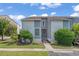 Charming townhome with a well-manicured lawn and blue siding under a bright blue, partly cloudy sky at 4049 Fairway Lakes Dr. # 4049, Myrtle Beach, SC 29577