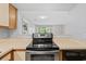 The kitchen has countertops, a range oven, and a view into the living room at 4049 Fairway Lakes Dr. # 4049, Myrtle Beach, SC 29577
