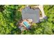 Aerial view of a home surrounded by green trees and featuring a pool and lounge area in the backyard at 41 Sunfield Dr., Calabash, SC 28467