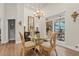 Cozy dining room with glass table, ornate chairs, and a sliding glass door to the outdoor patio at 41 Sunfield Dr., Calabash, SC 28467