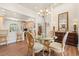 Open floor plan featuring a glass dining table with ornate chairs that connects to the kitchen at 41 Sunfield Dr., Calabash, SC 28467