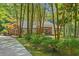 Charming brick home nestled amongst trees, featuring a covered entrance and mature landscaping at 41 Sunfield Dr., Calabash, SC 28467