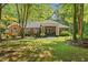 Lovely brick home with a portico entry surrounded by lush trees and a well-manicured lawn at 41 Sunfield Dr., Calabash, SC 28467