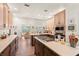 Open kitchen with an island cooktop, breakfast bar, stainless appliances, and a view to the backyard at 41 Sunfield Dr., Calabash, SC 28467