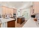 Well-lit kitchen featuring an island with cooktop, stainless steel appliances, and hardwood floors at 41 Sunfield Dr., Calabash, SC 28467