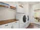 Bright laundry room with white cabinets, countertop, and modern side-by-side washer and dryer at 41 Sunfield Dr., Calabash, SC 28467